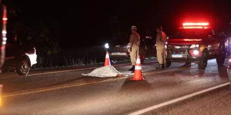 Corpo da vítima coberto por lençol em rodovia. (Fotos: Osmar Veiga)