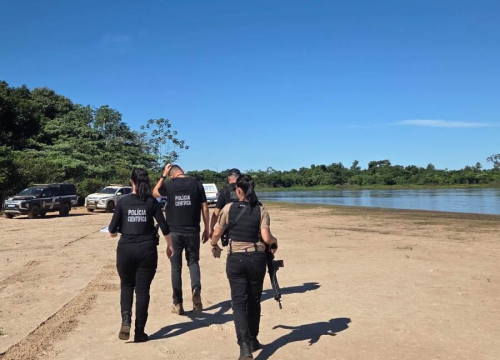 Policiais na margem do Rio Taquari, onde foragido foi encontrado morto (Foto: Divulgação)